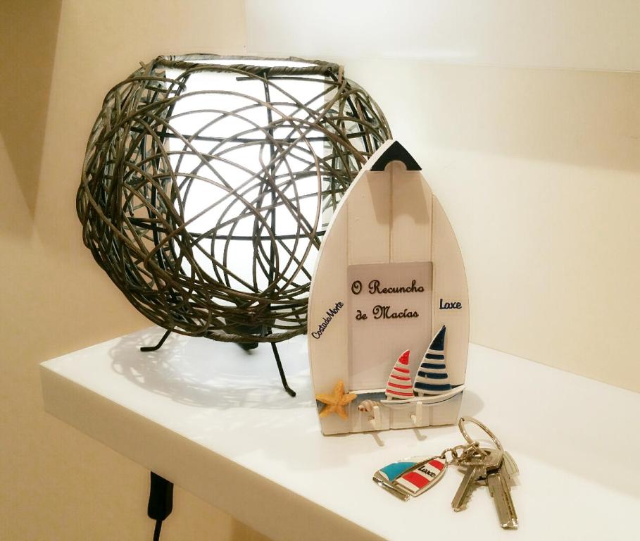 a surfboard and a ball on a counter with keys at O Recuncho de Macías in Laxe