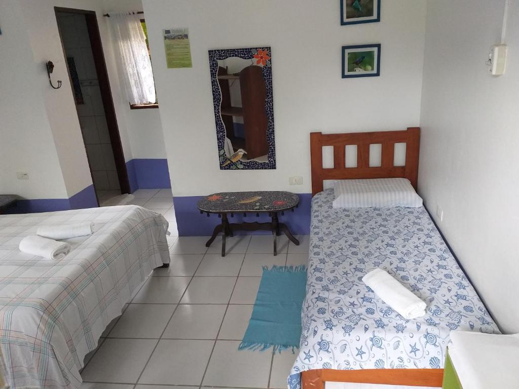 Postel nebo postele na pokoji v ubytování Pousada Recanto dos Pássaros