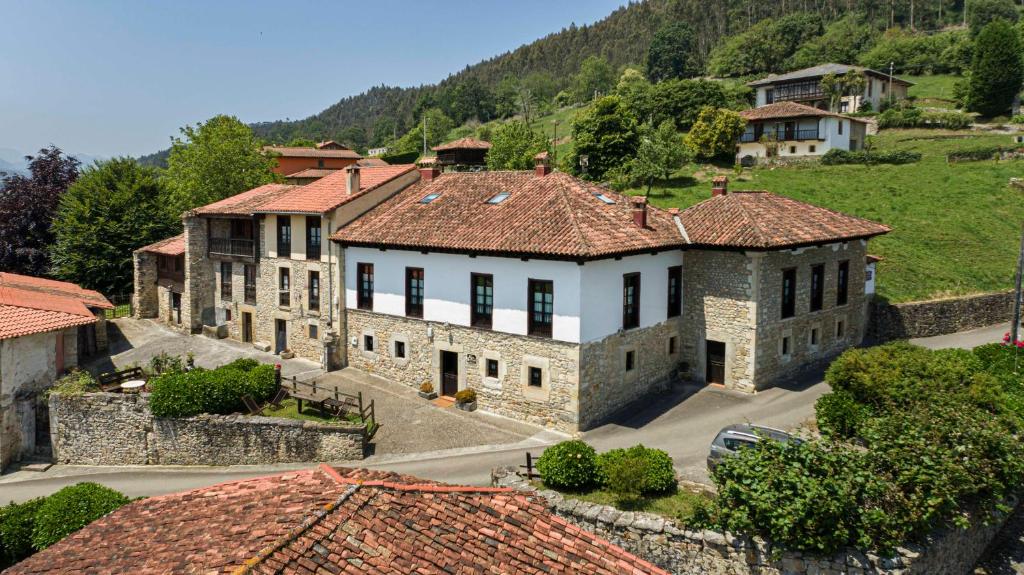 an aerial view of a house in a village at La Casona de Tresgrandas in Tresgrandas