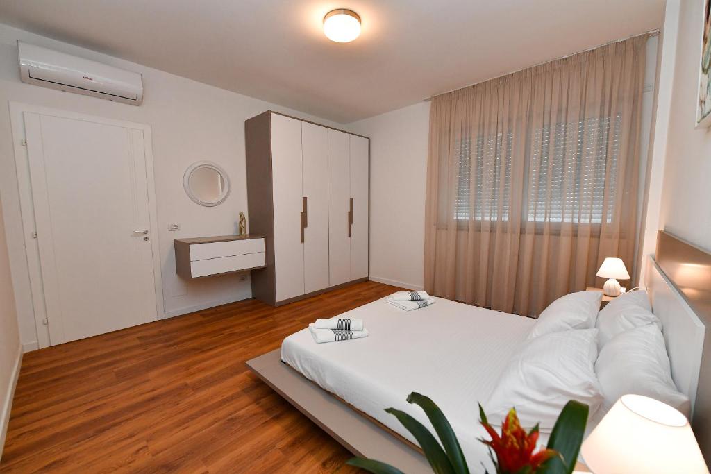 Postel nebo postele na pokoji v ubytování New Central Apartment