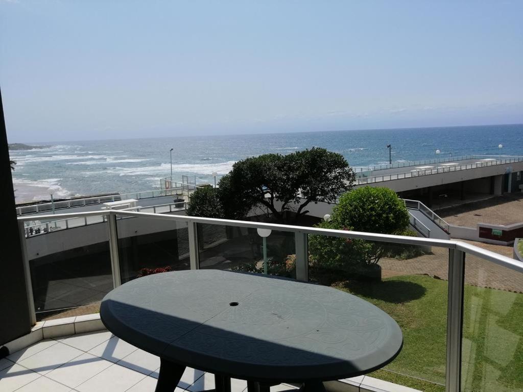 a table on a balcony with a view of the beach at Seagull 312 in Margate