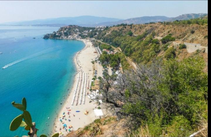 a view of a beach with people and the ocean at Andi in Stalettì
