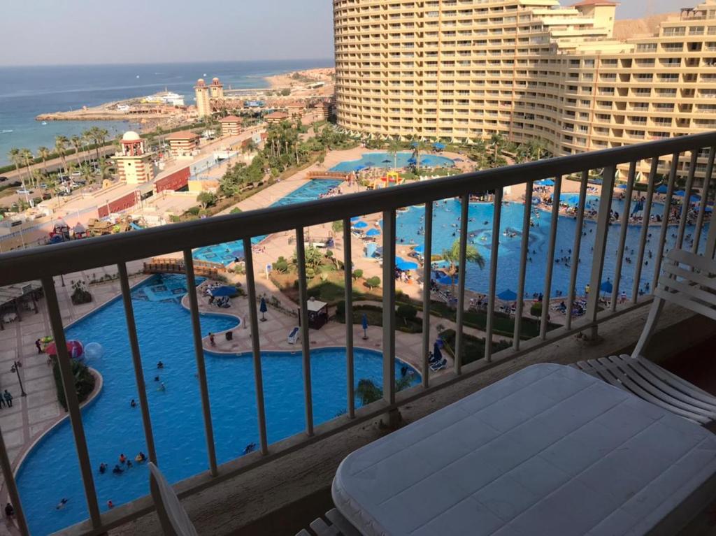 a view of a pool from a balcony of a resort at العين السخنة بورتو الاهرامات عائلات فقط in Ain Sokhna