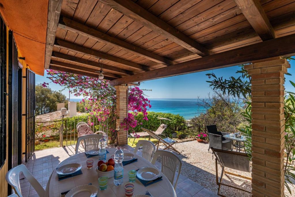 a table on a patio with a view of the ocean at Villa Laura in Monte Nai