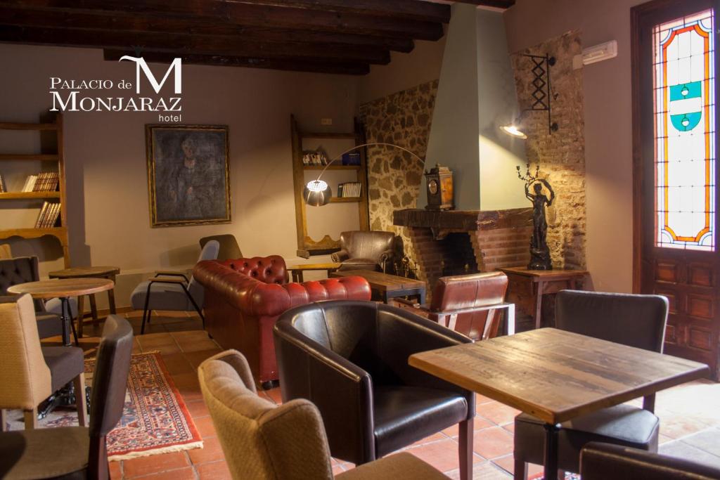 a restaurant with tables and chairs and a window at Palacio de Monjaraz in Avila