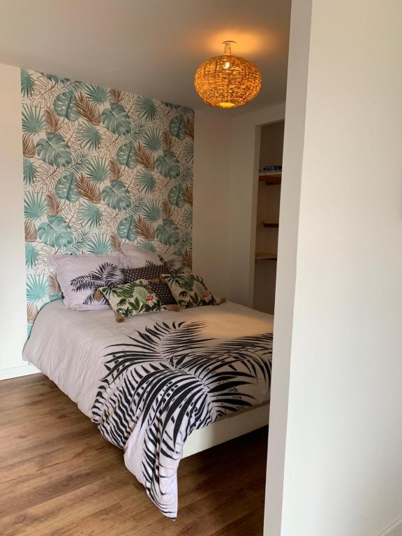 a bedroom with a bed with a zebra print wall at chez LULU appartement neuf au coeur de cozzano in Cozzano