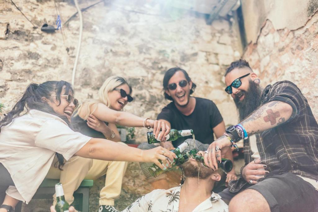 a group of people playing with beer bottles at Booze & Snooze Social Hostel in Split