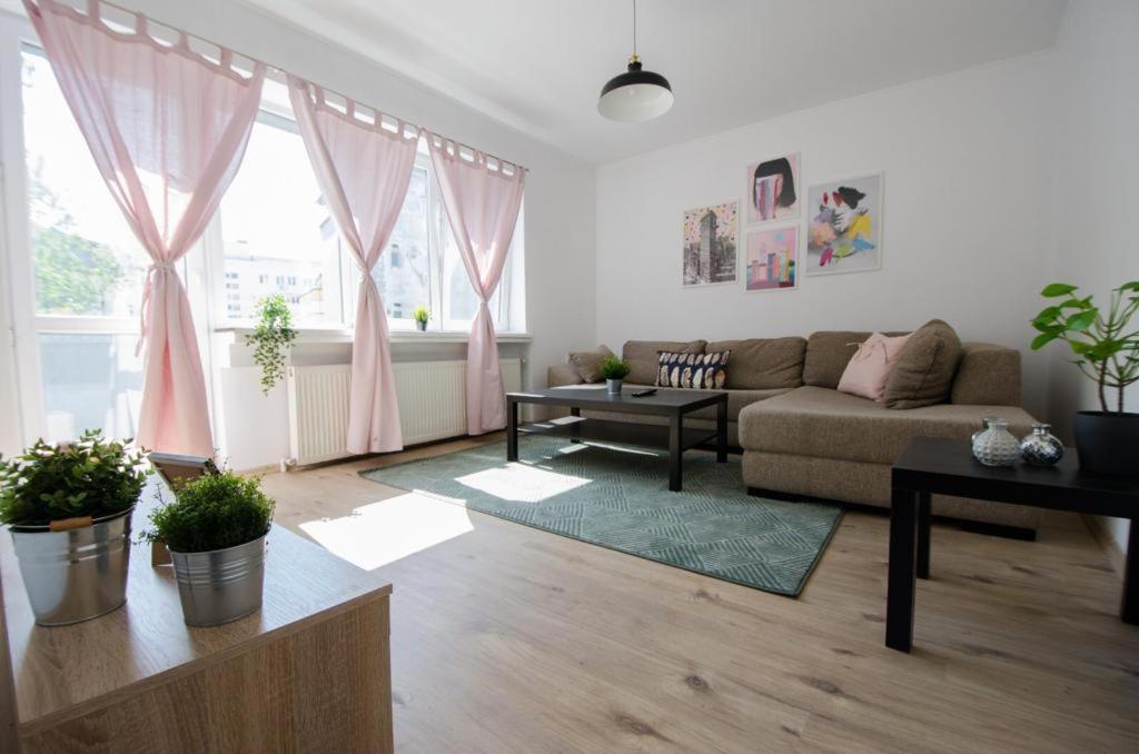 a living room with a couch and a table at Bright apartment near Cismigiu and Old Town in Bucharest