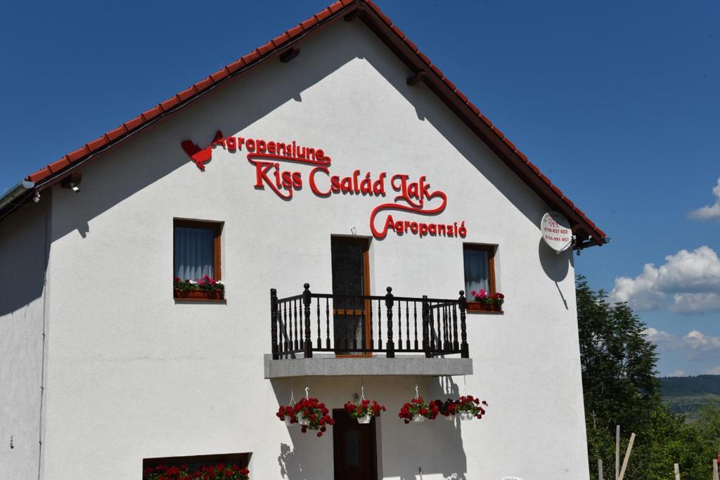 a white building with red letters on it at Atyha Kiss Csalad Lak Agropanzio in Atia