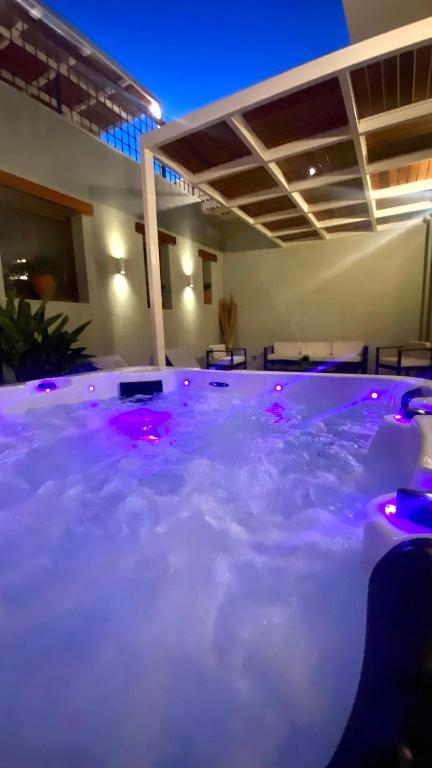 a hot tub with purple lights in a room at Andros 4 All Seasons Villas & Suites in Andros