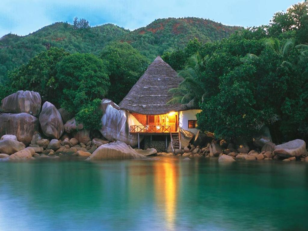 a house on the shore of a body of water at Chauve Souris Relais in Anse Volbert Village