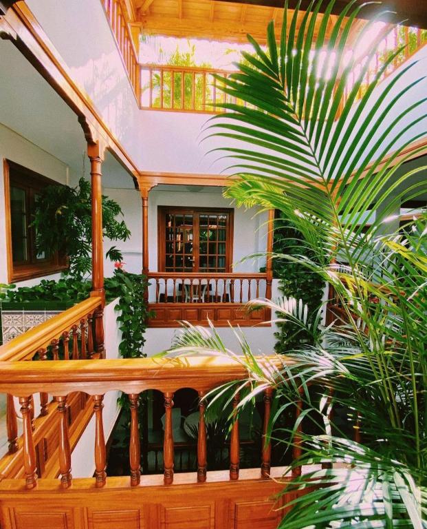 a wooden staircase in a house with plants at Apartamentos Tapahuga in Playa de Santiago