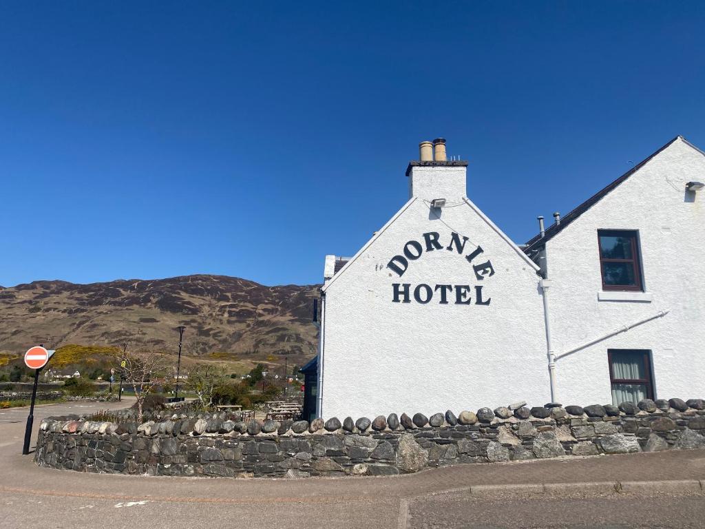 a white building with a sign on the side of it at The Dornie in Dornie