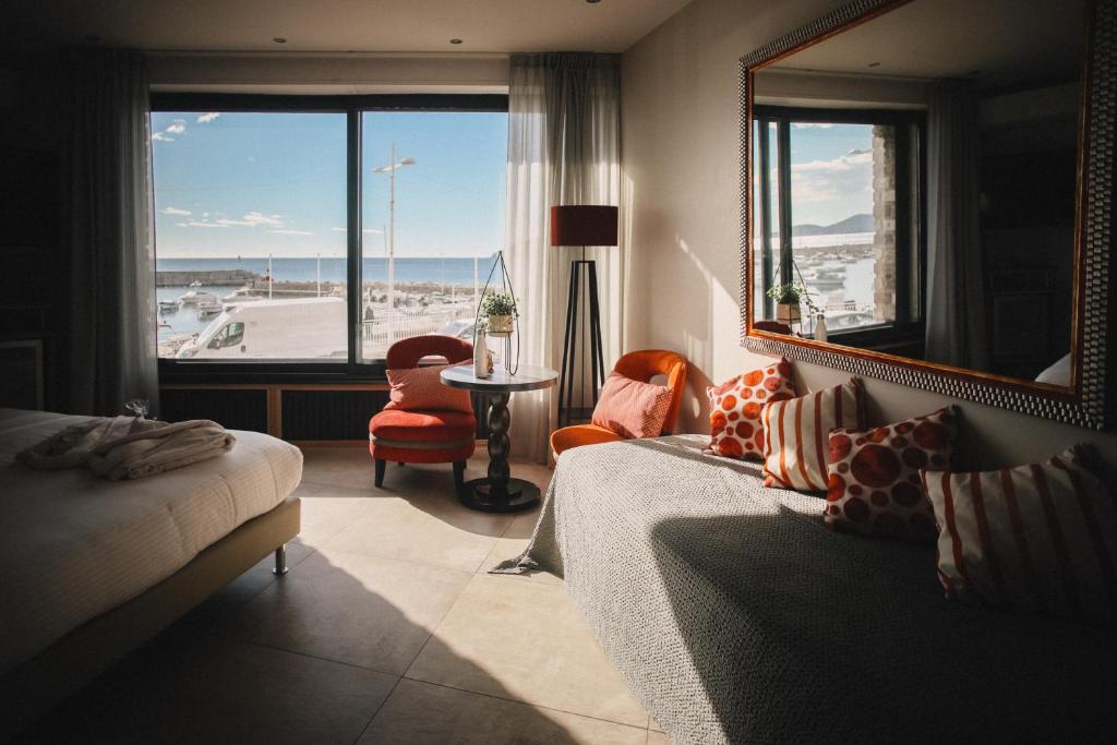 a bedroom with a bed and a view of the ocean at Best Western Plus La Corniche in Toulon
