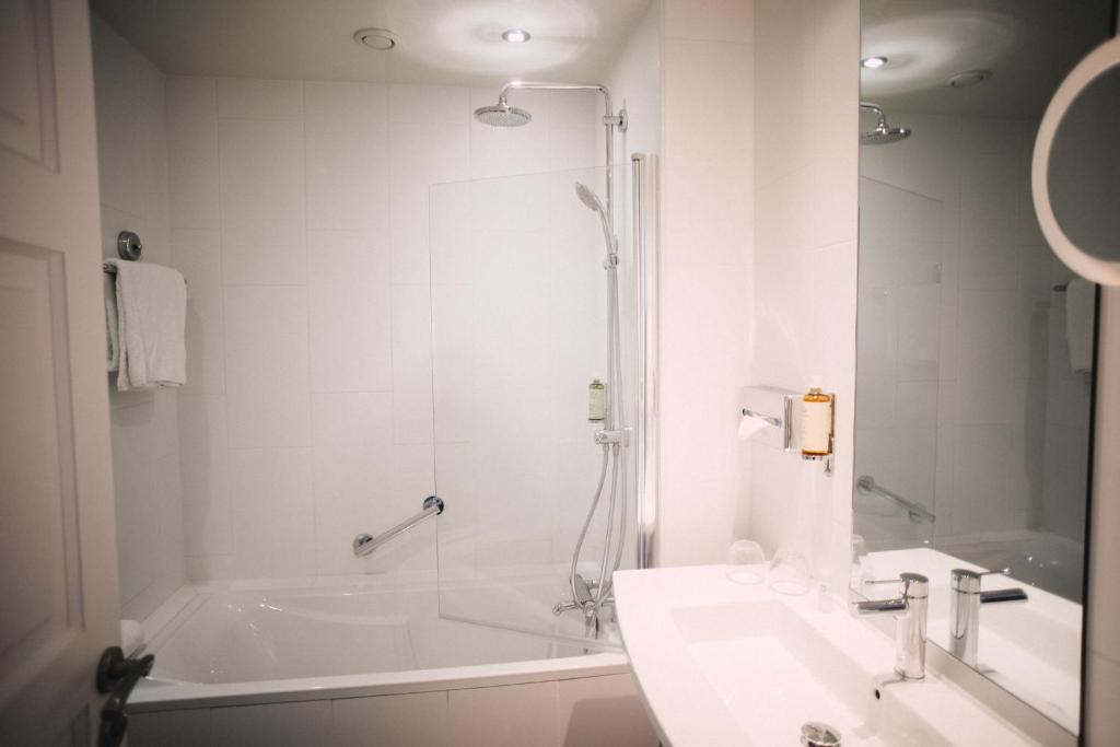 a bathroom with a shower and a sink and a tub at Best Western Plus La Corniche in Toulon