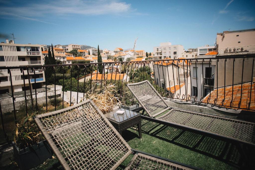 a balcony with two chairs and a table at Best Western Plus La Corniche in Toulon