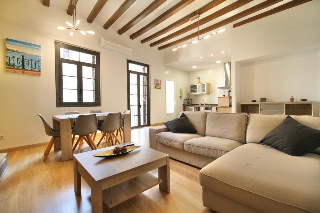 a living room with a couch and a table at Mediterranean Way - Sant Domenec in Tarragona