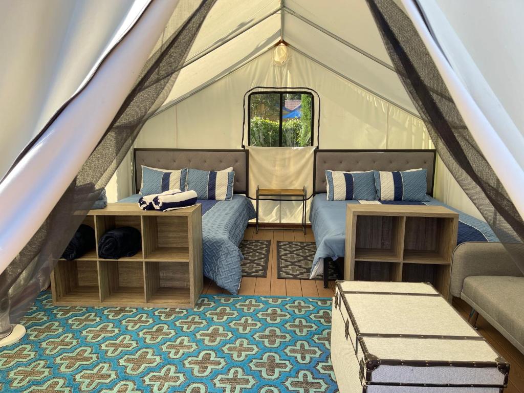 a room in a tent with two beds and a couch at Surrey Resort and Gym in Guerneville