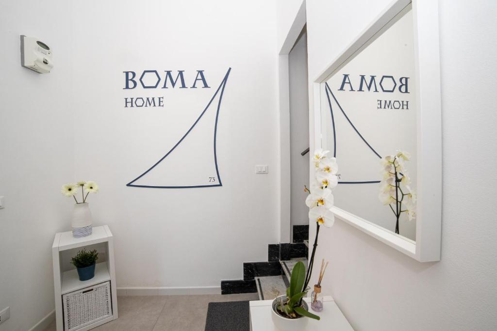 a hallway with a staircase with a sign on the wall at Boma Home in Avola