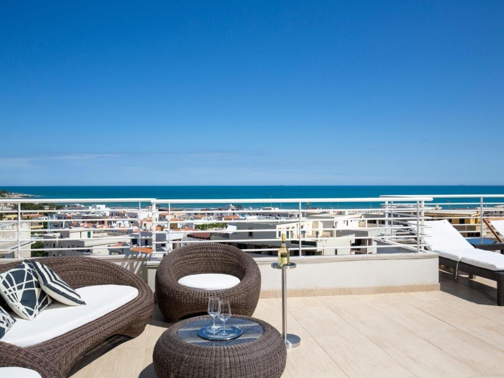 a balcony with chairs and tables on a boat at Navicri B&B in Vieste