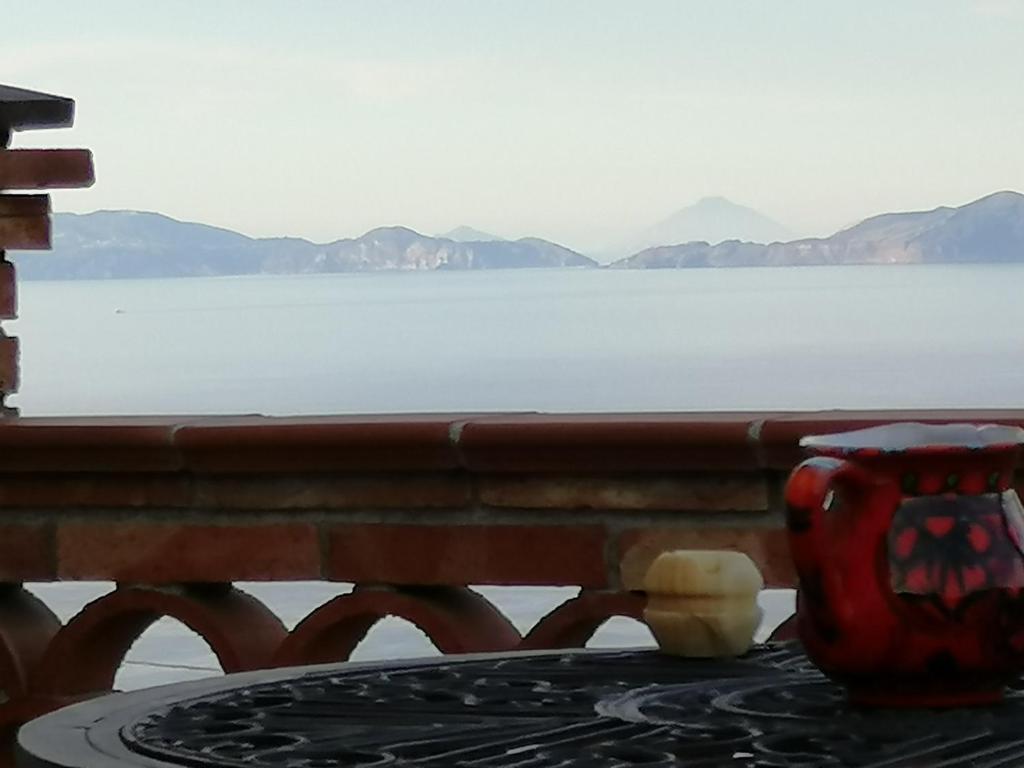 a table in front of a view of the water at L'orangerie in Capo dʼOrlando