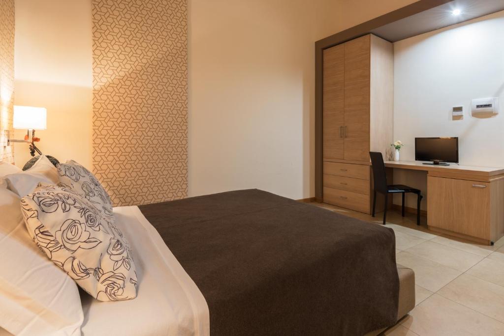 Postel nebo postele na pokoji v ubytování Hotel Vittorio Veneto