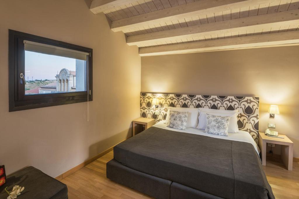 Postel nebo postele na pokoji v ubytování Hotel Vittorio Veneto