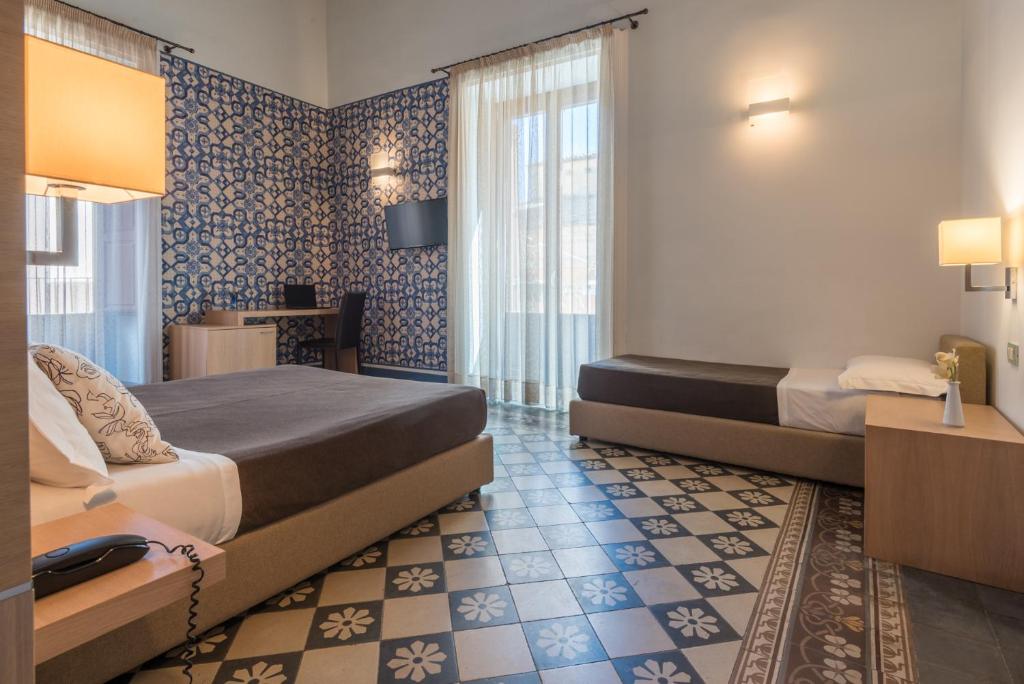 Postel nebo postele na pokoji v ubytování Hotel Vittorio Veneto