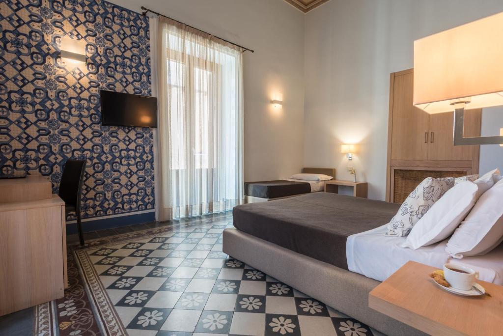 Postel nebo postele na pokoji v ubytování Hotel Vittorio Veneto