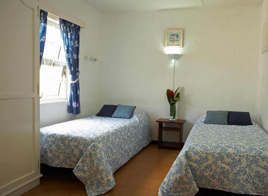 Postel nebo postele na pokoji v ubytování La Pointe Villas