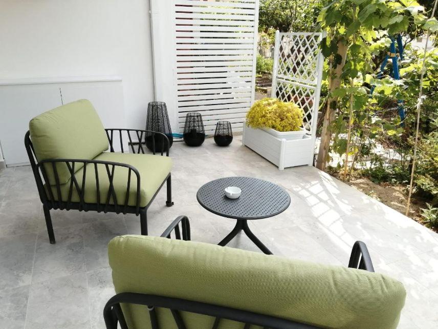 a patio with two chairs and a table and a tableablish at Loris House in Tropea