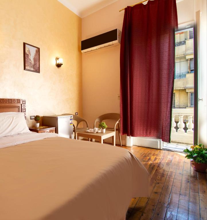 A bed or beds in a room at Minerva Grand Boutique