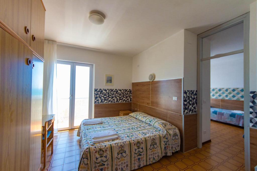 Postel nebo postele na pokoji v ubytování Hotel Calipso