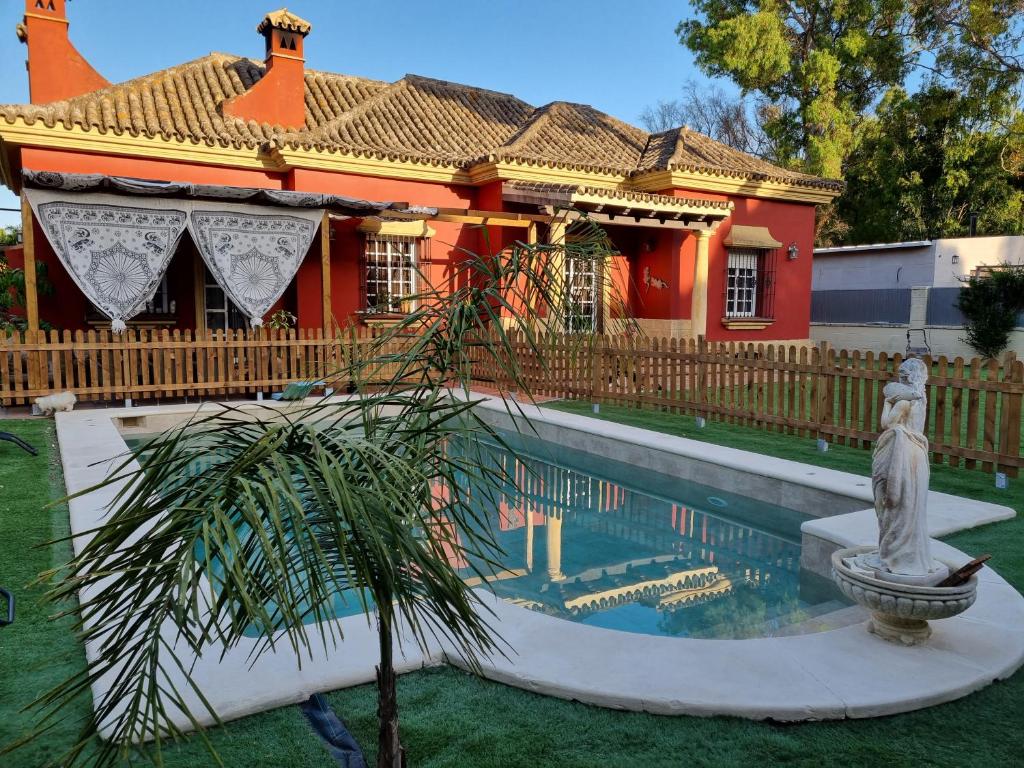 a house with a swimming pool in front of a house at VACACIONES DE LUJO.CHALET PISCINA Y PLAYA.EL PUERTO in El Puerto de Santa María