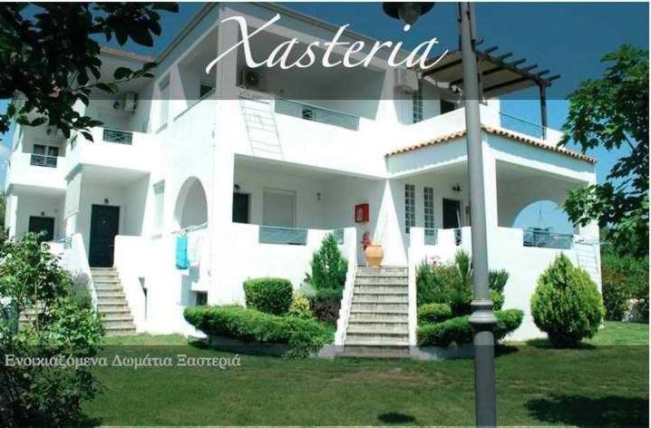 a white house with stairs in front of it at Xasteria in Velika