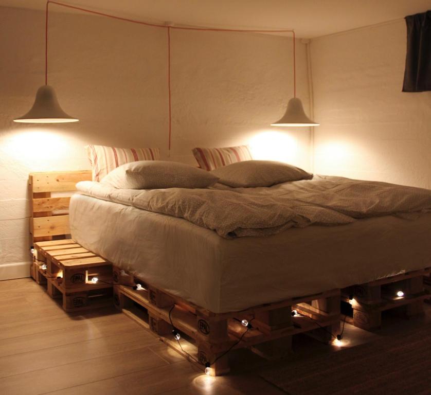 a bedroom with a bed with two lights on it at Cosy Private room close to Copenhagen centre in Copenhagen