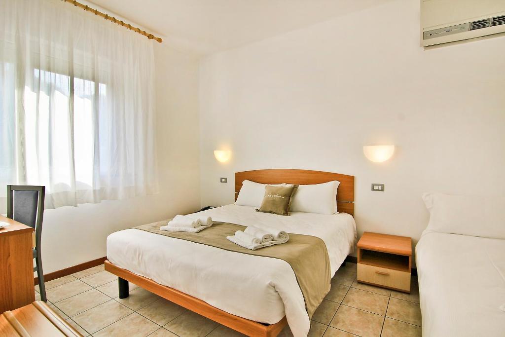 Posteľ alebo postele v izbe v ubytovaní Hotel La Perla