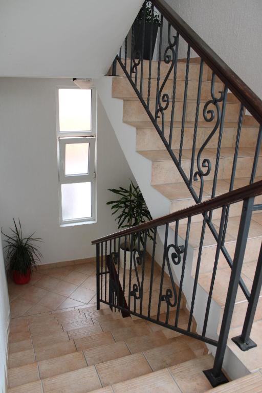 a staircase with a dog laying on the floor at Apartments Maria Rab in Barbat na Rabu
