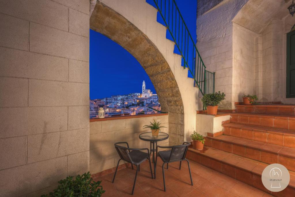 a table and chairs on a balcony with a view of the city at Da Zia Lalla in Matera