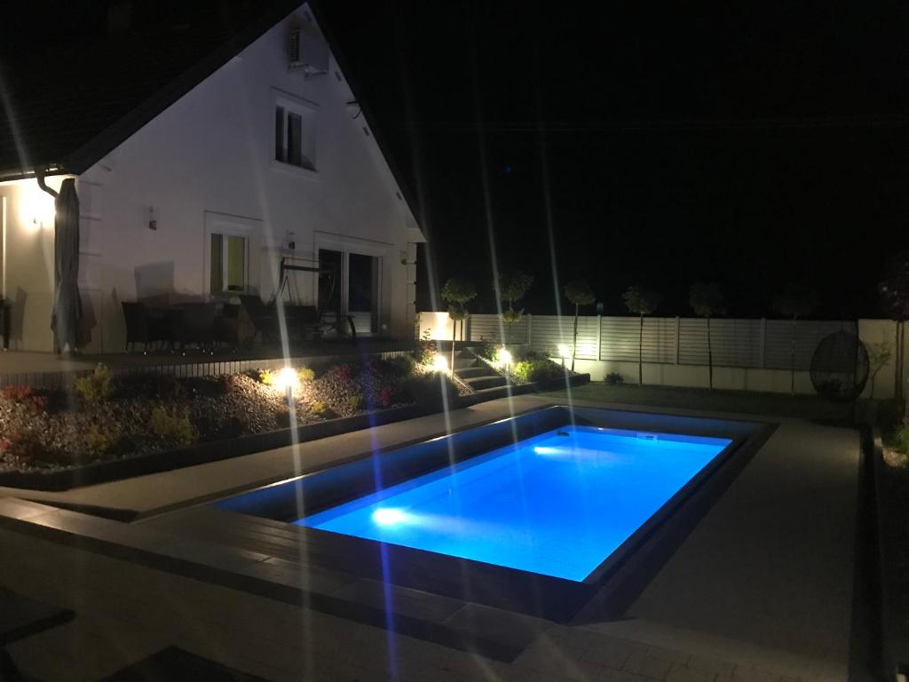 a swimming pool in the middle of a yard at night at Sieburczynianka in Wizna