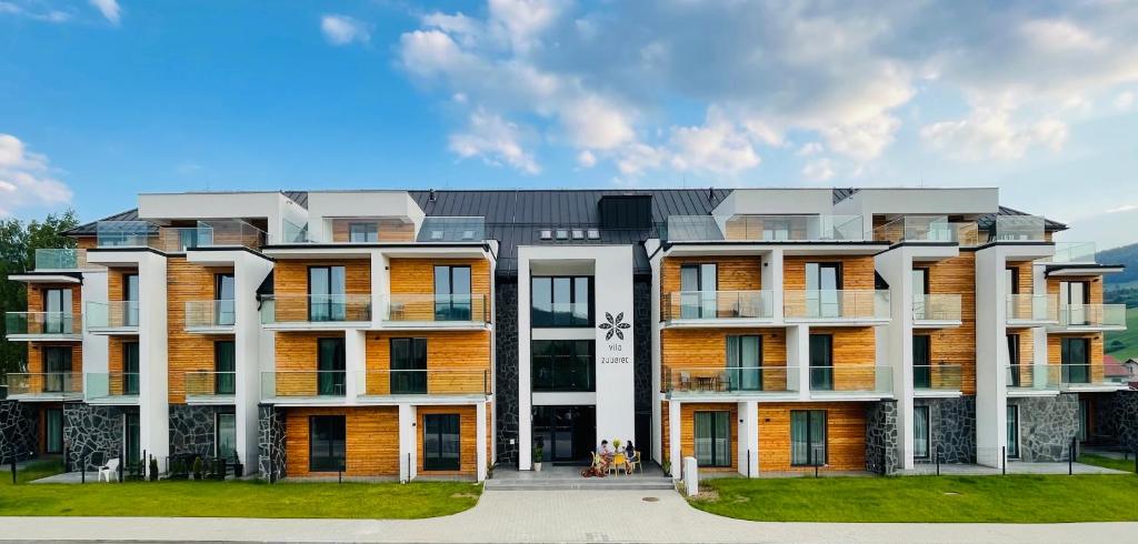 a large building with white and orange at Apartmán Vila Zuberec in Zuberec