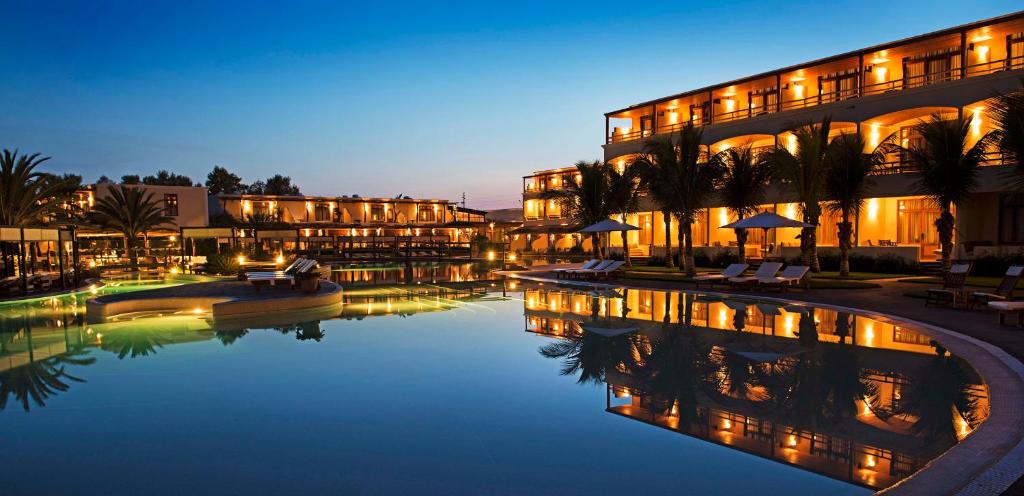 um hotel com piscina à noite em La Hacienda Bahia Paracas em Paracas