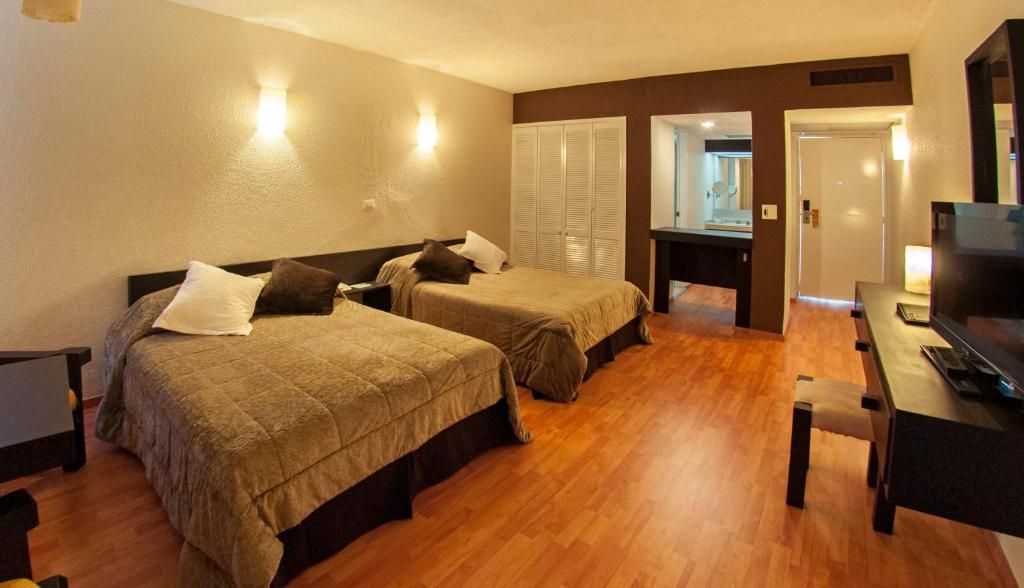 Postel nebo postele na pokoji v ubytování Gran Hotel Xalapa