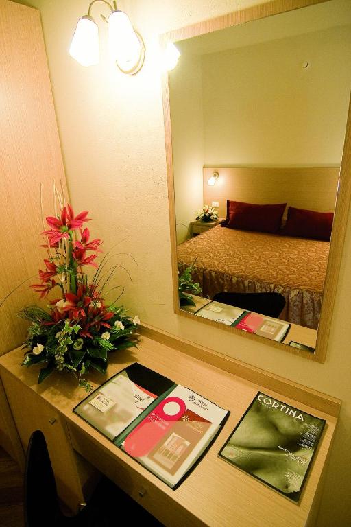 Łóżko lub łóżka w pokoju w obiekcie Hotel Granducato