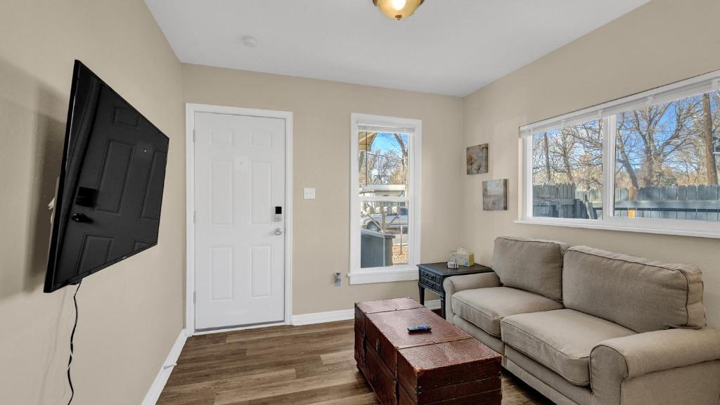 a living room with a couch and a flat screen tv at Escape to Serenity in Colorado Springs