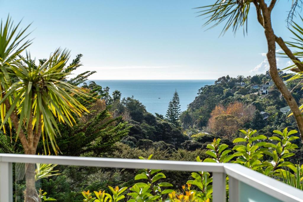a balcony with a view of the ocean at Villa Haven - Waiheke Escapes in Palm Beach