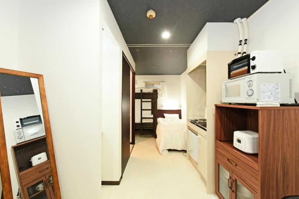 a small room with a kitchen with microwaves at Heights N7 / Vacation STAY 7573 in Sapporo