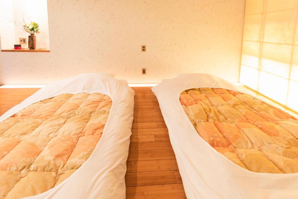 Postel nebo postele na pokoji v ubytování Yushintei