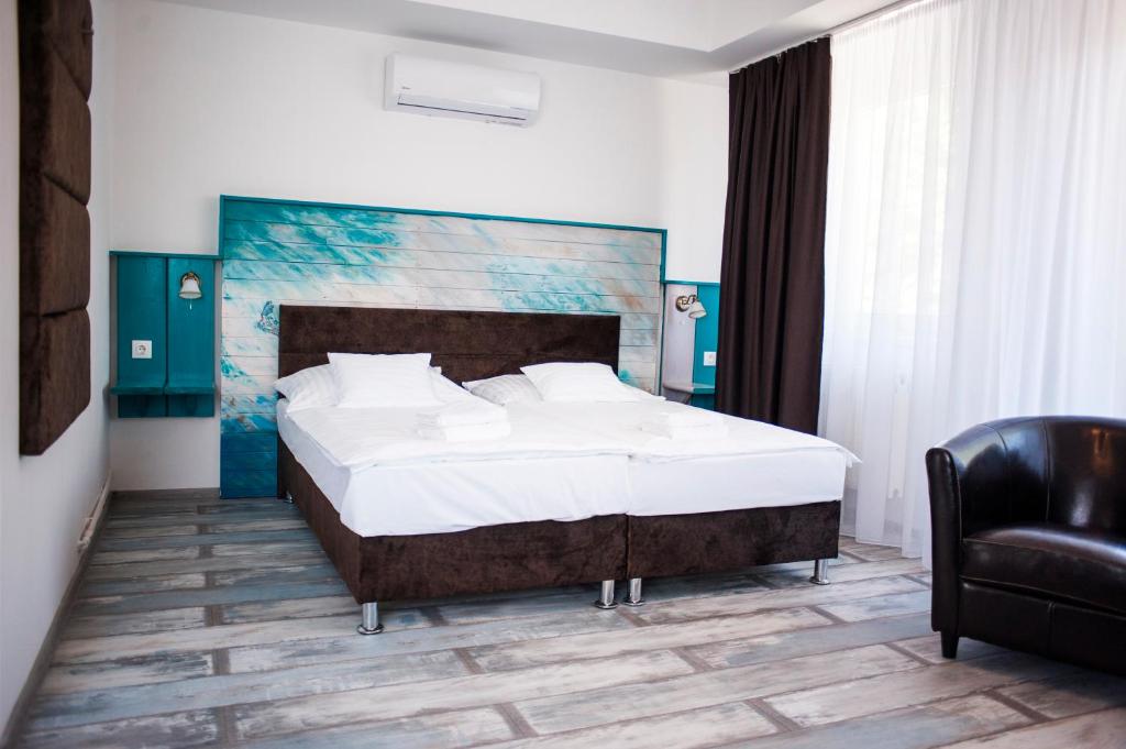 A bed or beds in a room at Q-Panzió