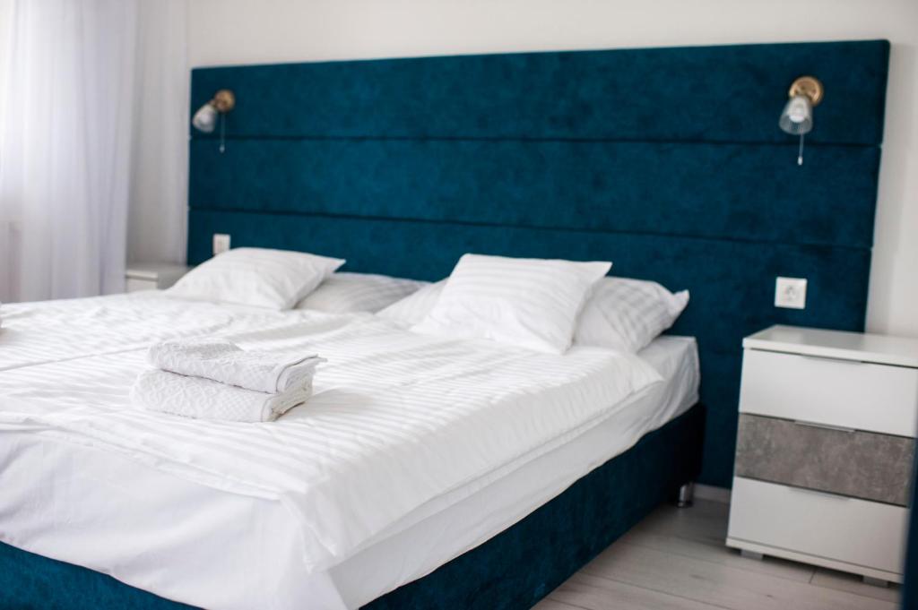 A bed or beds in a room at Q-Panzió